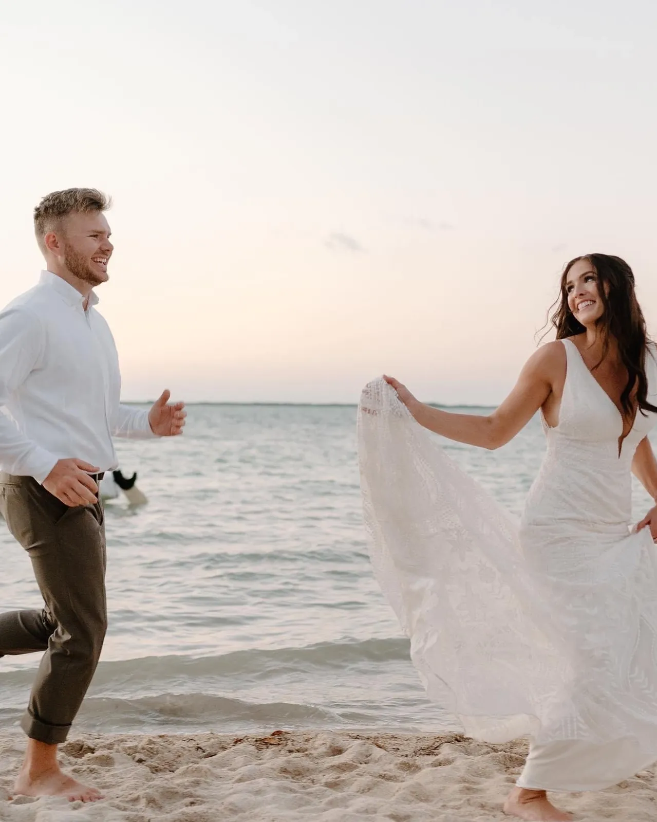 Couple running barefoot on the beach