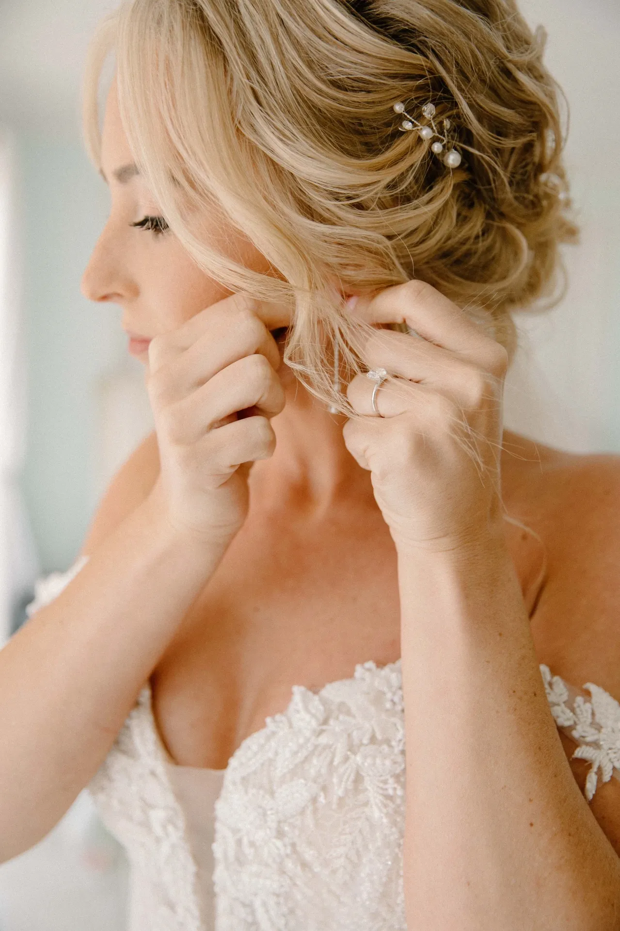 Bride laughing at &lsquo;hello gorgeous&rsquo; wall