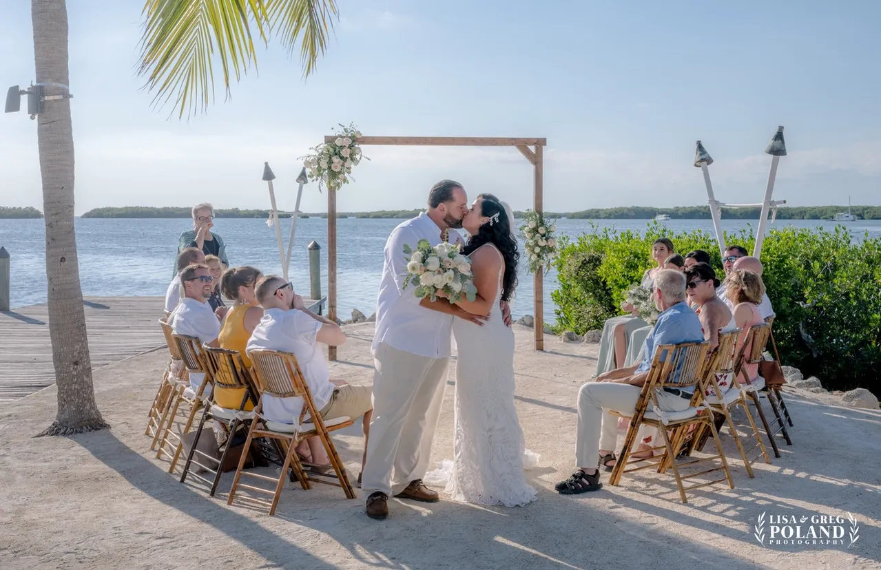 Bridal party laughing on the beach